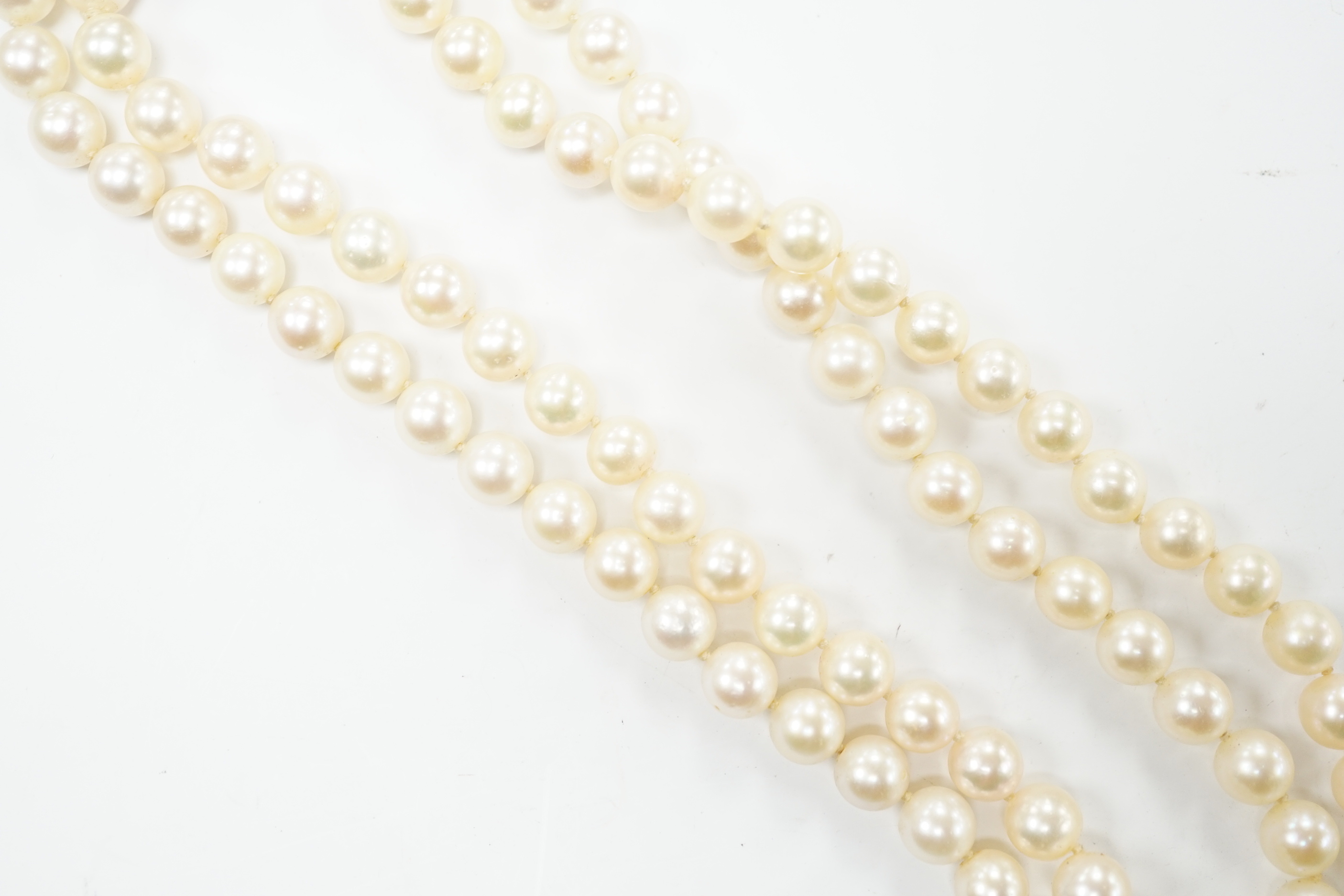 A double strand cultured pearl choker necklace with yellow and white metal, ruby and diamond cluster set clasp, 40cm.